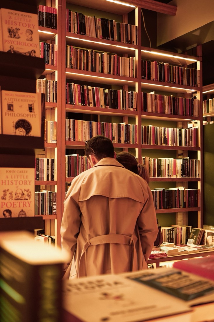 A couple browsing shelves in a bookstore