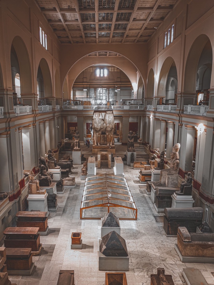 A grand museum hall filled with ancient artifacts