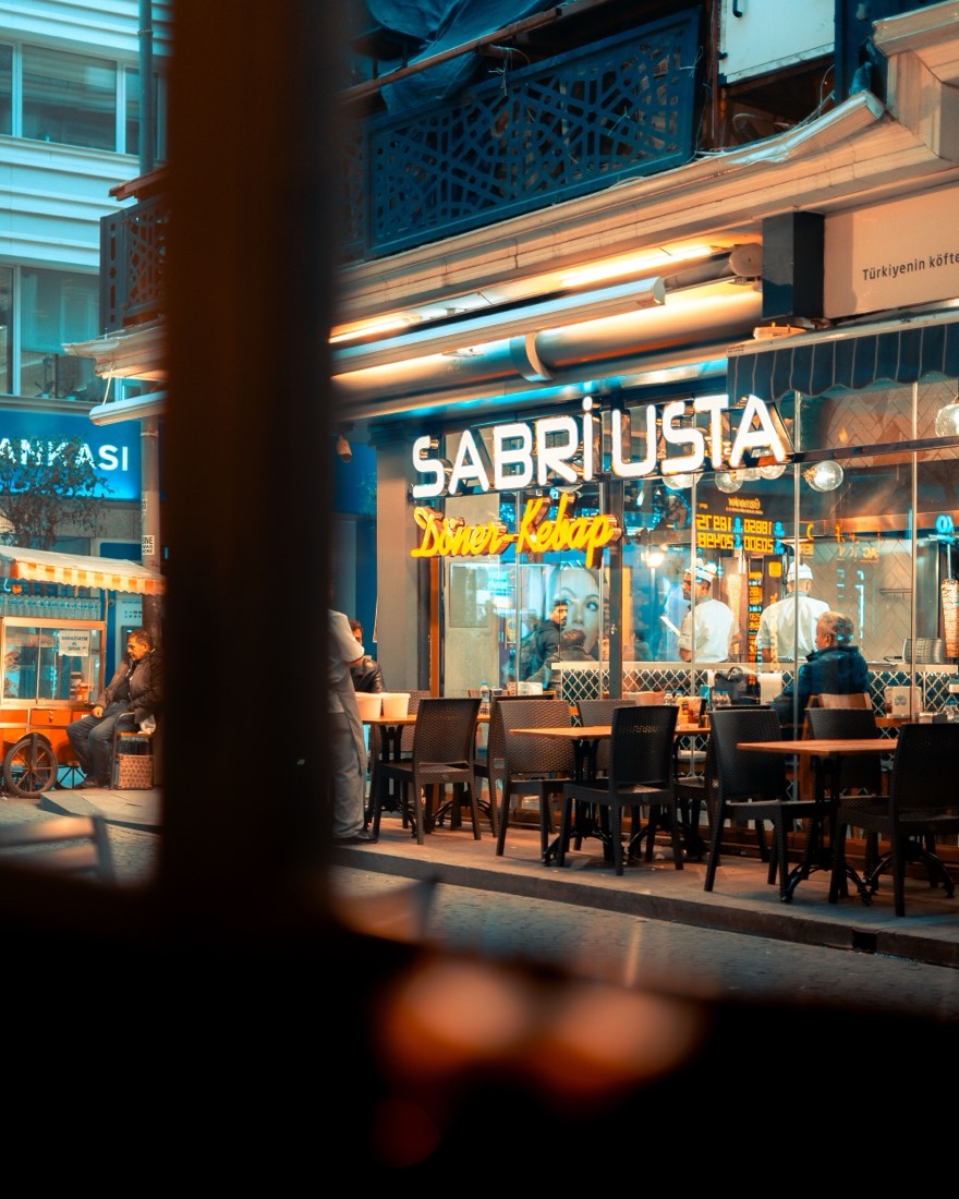 A neon-lit street food spot at night