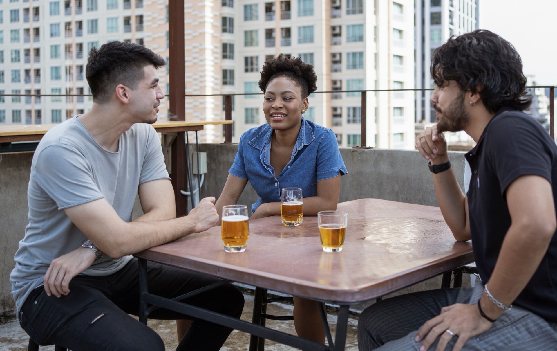 Friends on a rooftop overlooking the city